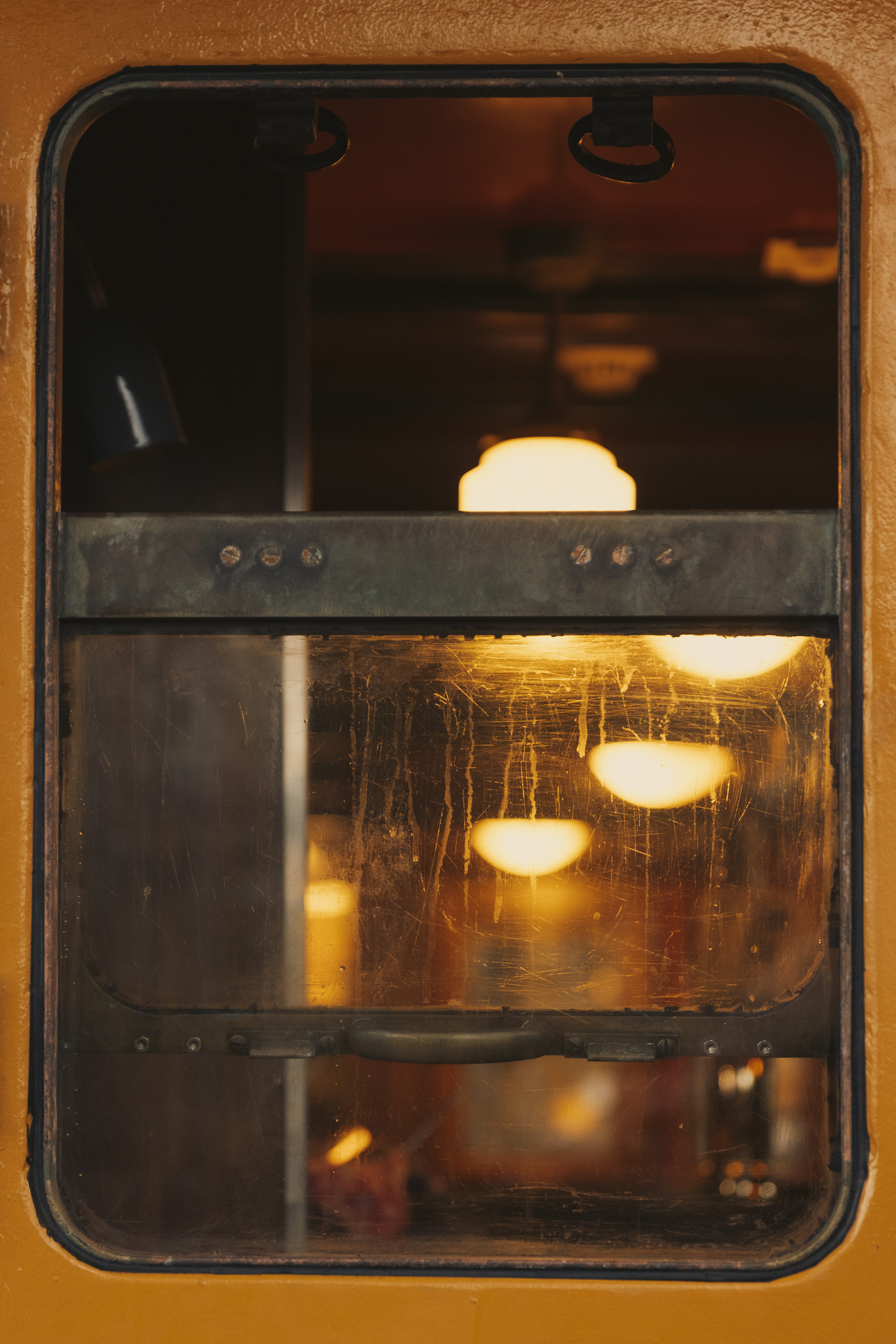 Warm light through a porthole — life aboard Bark EUROPA at anchor